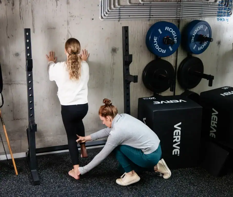 Claire Rees, Sports and Exercise Physiotherapist, helping a young patient with her posture